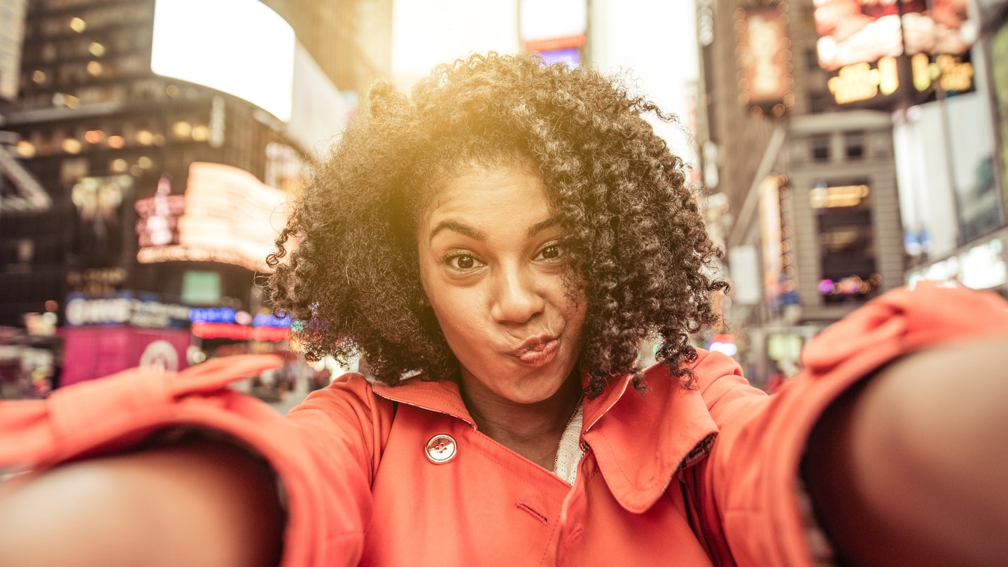 Young american woman taking selfie in New york, Time square.