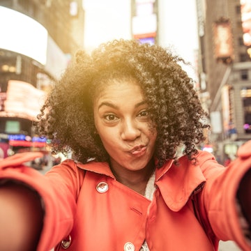Young american woman taking selfie in New york, Time square.