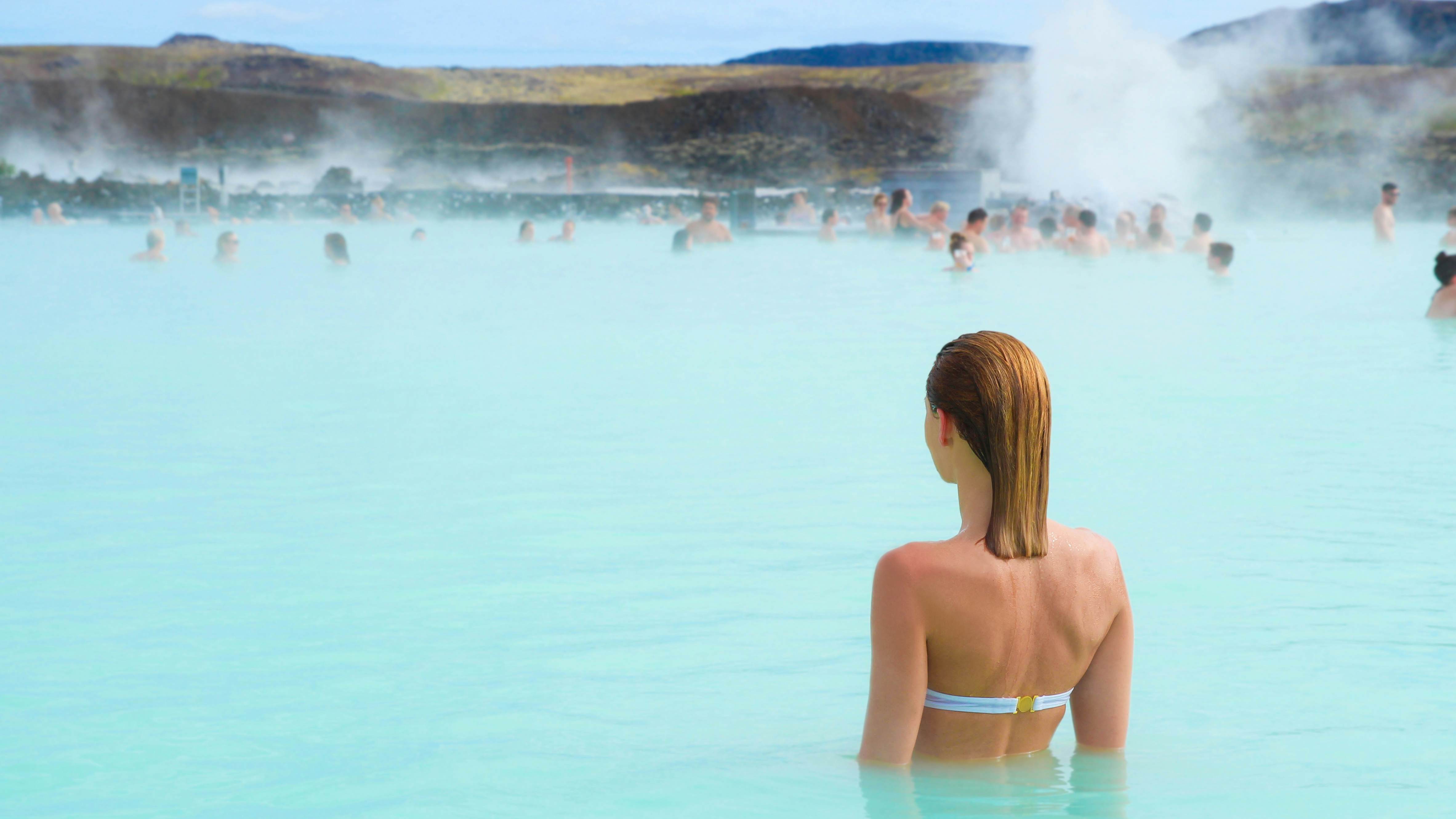 Woman enjoy of spa in hot spring Blue Lagoon in Iceland