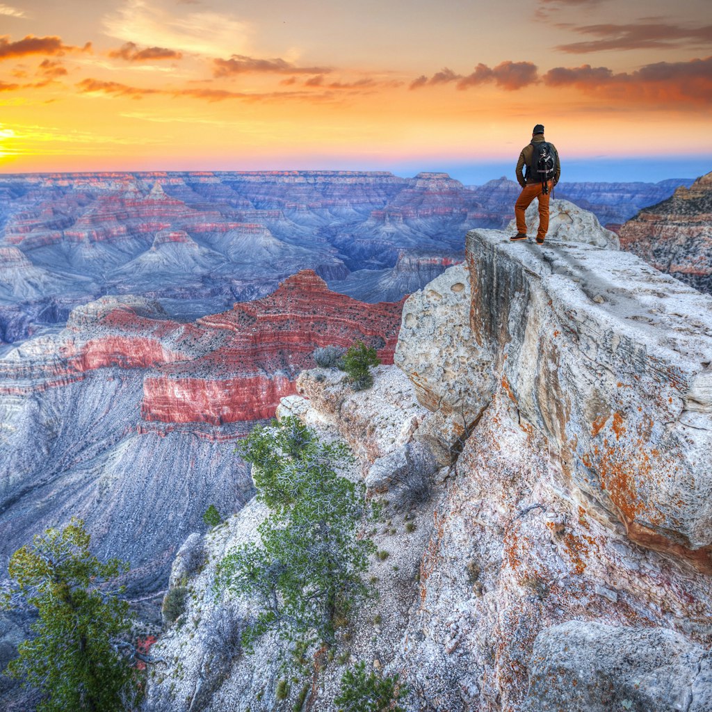 Man in the Grand Canyon at sunrise. tourist in America