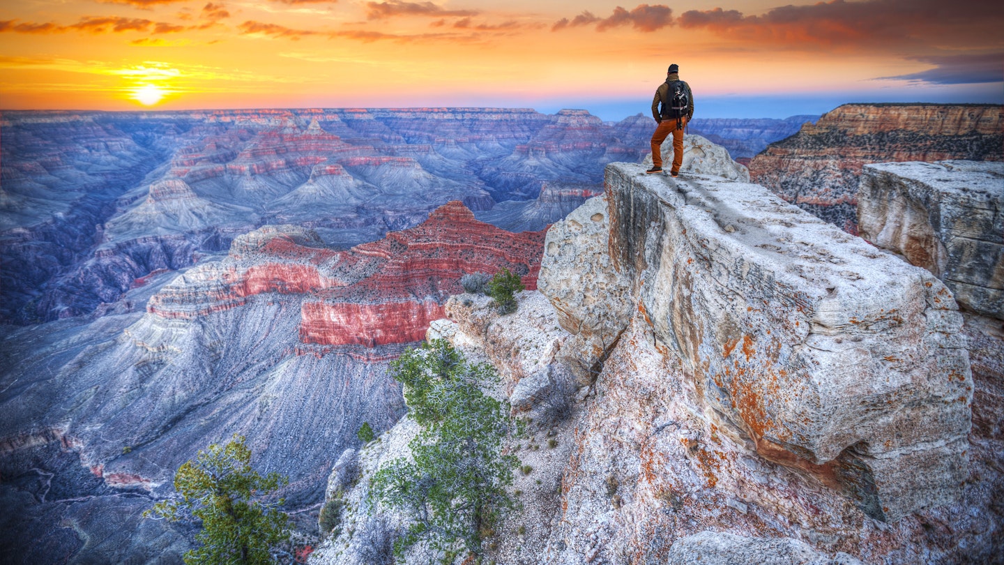 Man in the Grand Canyon at sunrise. tourist in America