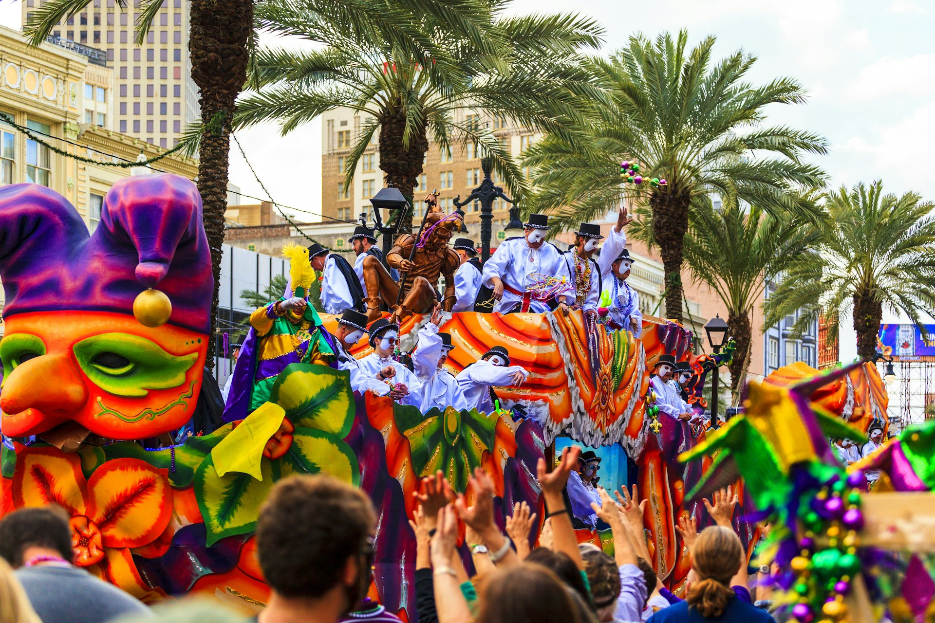 A colorful krewe floats through the streets of New Orleans during a Mardi Gras parade