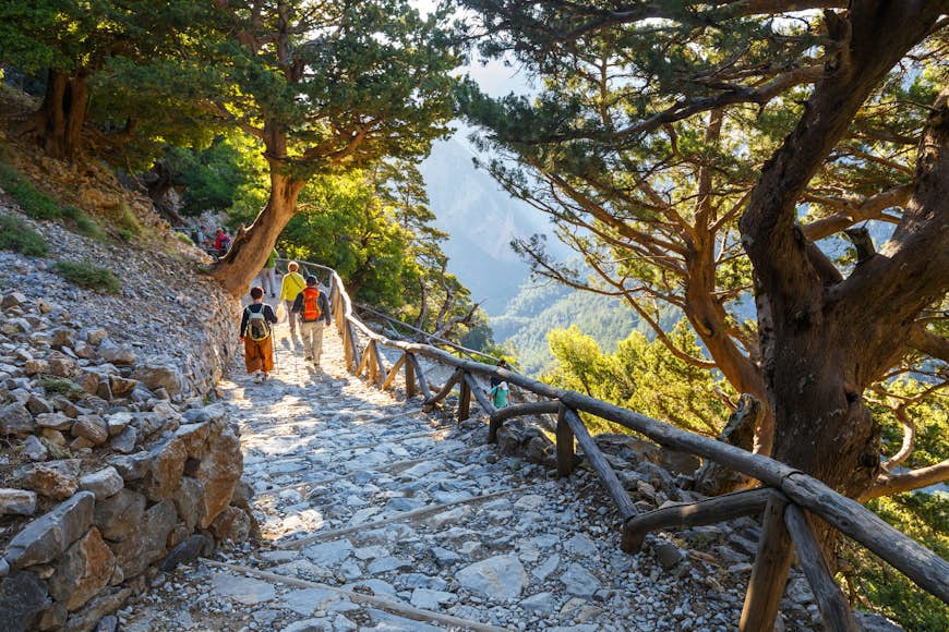 A pair of hikers descend a staircase at the Samaria Gorge