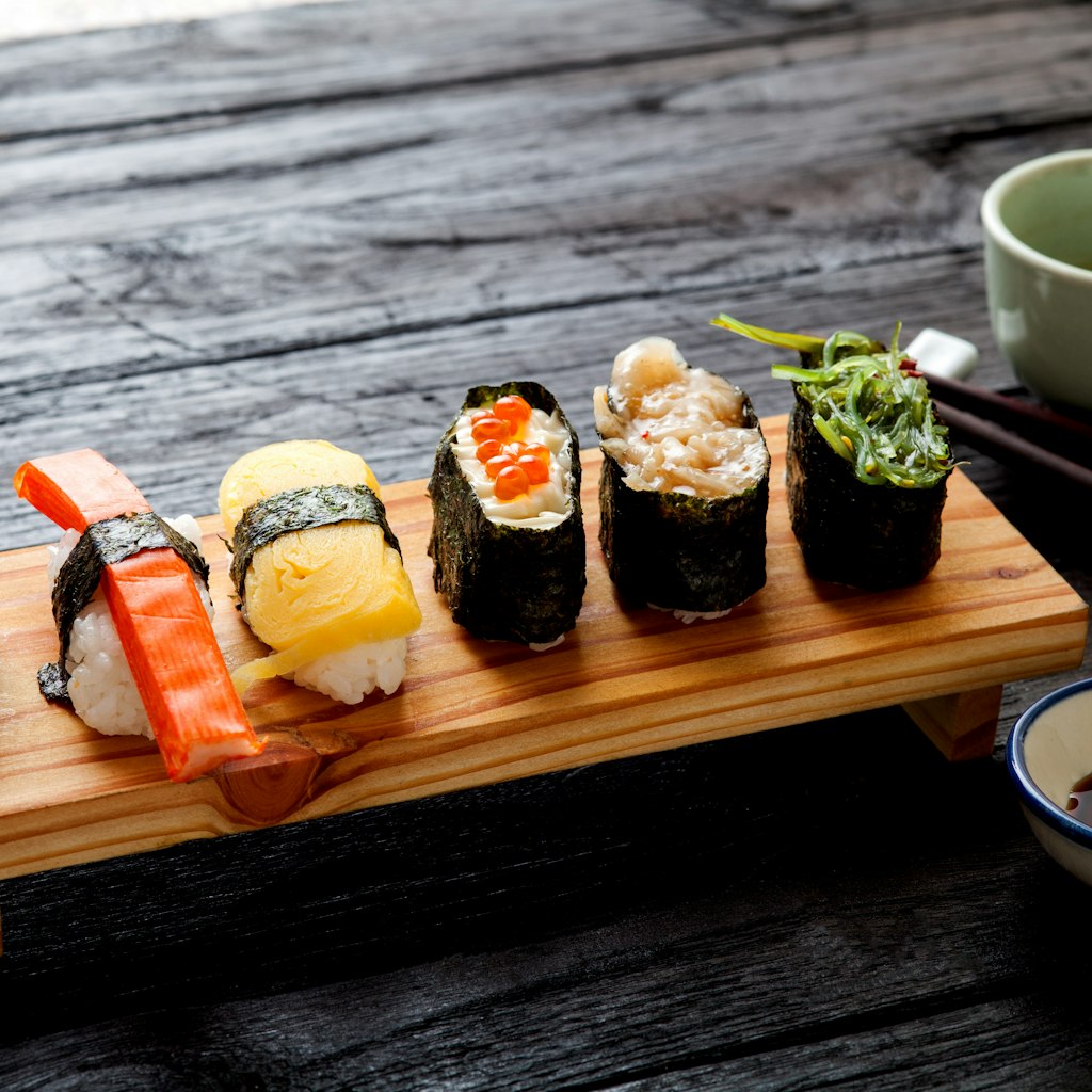 Sushi Set served on dark wooden table.