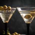 Two glasses of Dry Martini, classic cocktail with olives, vodka and gin served cold
