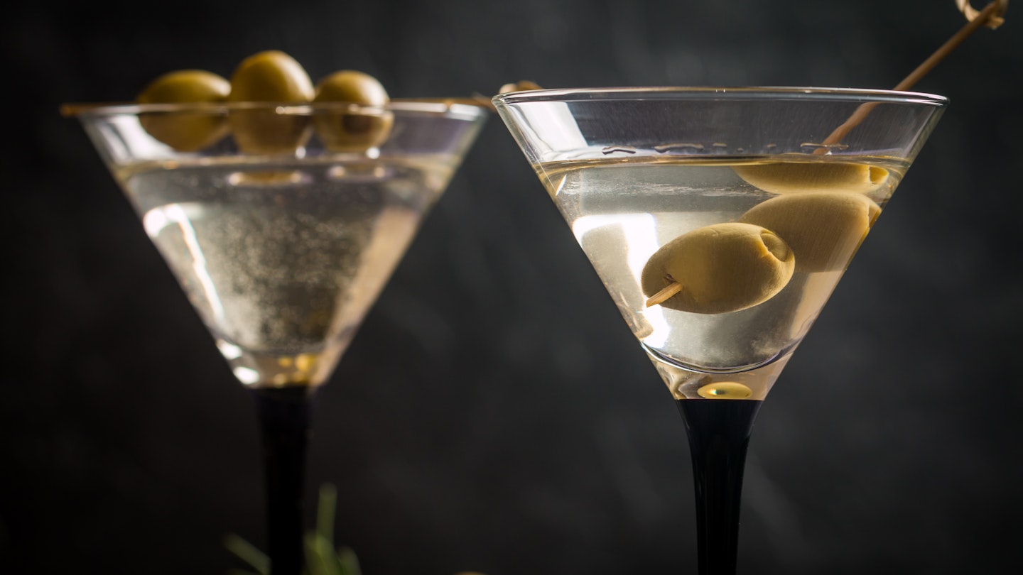 Two glasses of Dry Martini, classic cocktail with olives, vodka and gin served cold