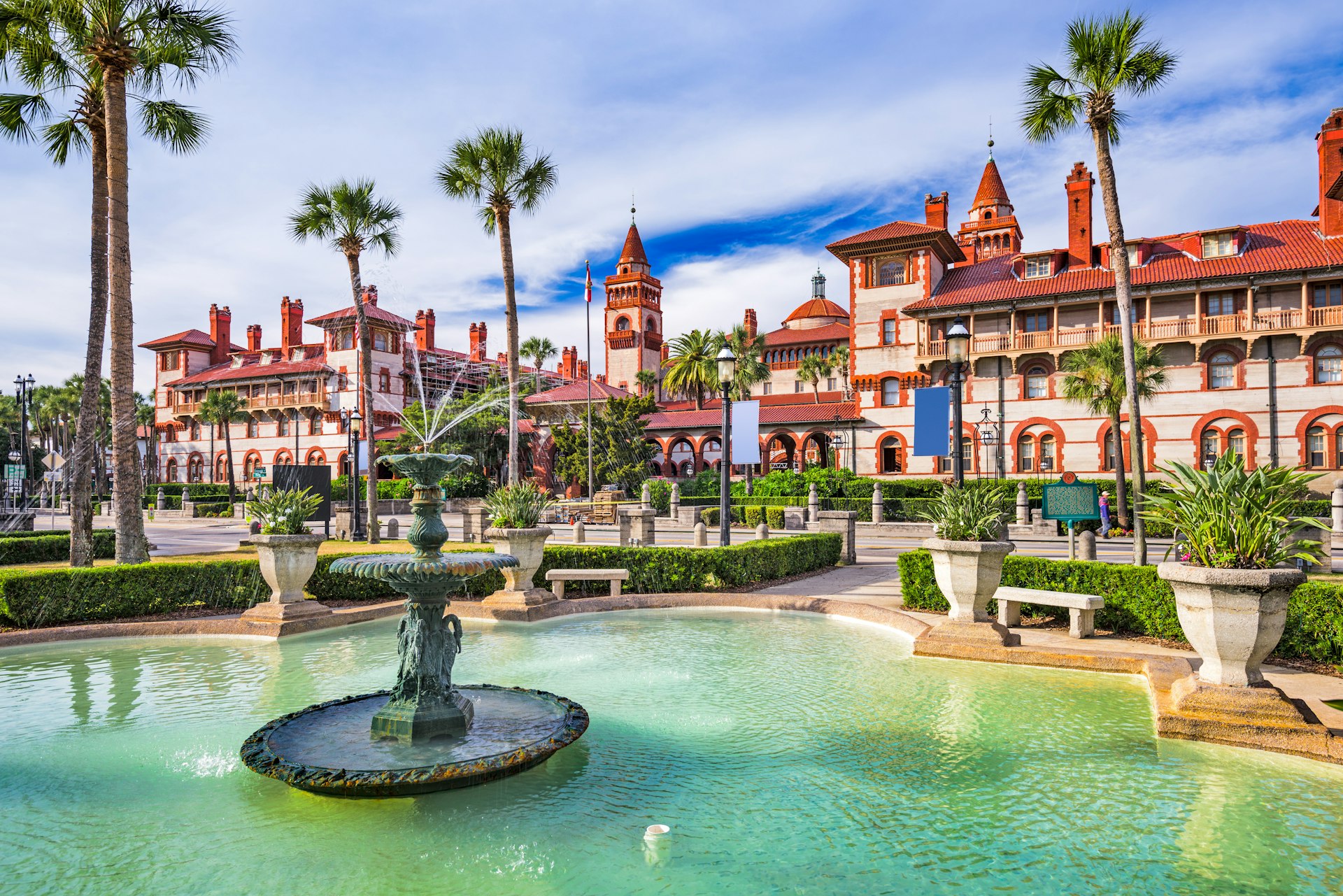 Fountains and courtyard in front of a large Spanish Renaissance-style building