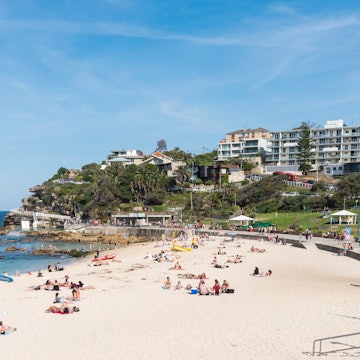 Sydney, Australia - April 9, 2016: Bronte beach along the Bondi to Coogee coastal walk. A cliff top coastal walk featuring stunning views, beaches, parks, cliffs, bays and rock pools.