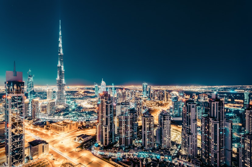Fantastic nighttime skyline with illuminated skyscrapers. Elevated view of downtown Dubai, UAE. Colourful travel background.