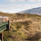 Rannoch, Scotland - May 11, 2016: The Caledonian Sleeper train crosses Rannoch Viaduct on the scenic West Highland Line railway in the Scottish Highlands.
