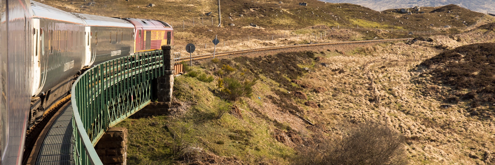 Rannoch, Scotland - May 11, 2016: The Caledonian Sleeper train crosses Rannoch Viaduct on the scenic West Highland Line railway in the Scottish Highlands.