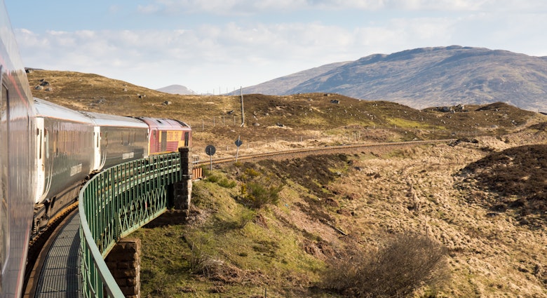 Rannoch, Scotland - May 11, 2016: The Caledonian Sleeper train crosses Rannoch Viaduct on the scenic West Highland Line railway in the Scottish Highlands.