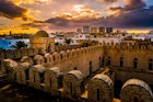 The fortress walls of the Ribat of Sousse during sunset.