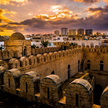 The fortress walls of the Ribat of Sousse during sunset.