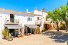 MAY 19, 2017: Traditional white houses and shops in Sant Joan de Labritja village.