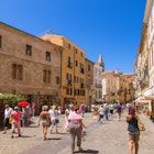 ALGHERO, SARDINIA, ITALY - JUL 07, 2016: Tourists on the street in the old town