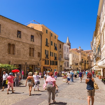 ALGHERO, SARDINIA, ITALY - JUL 07, 2016: Tourists on the street in the old town