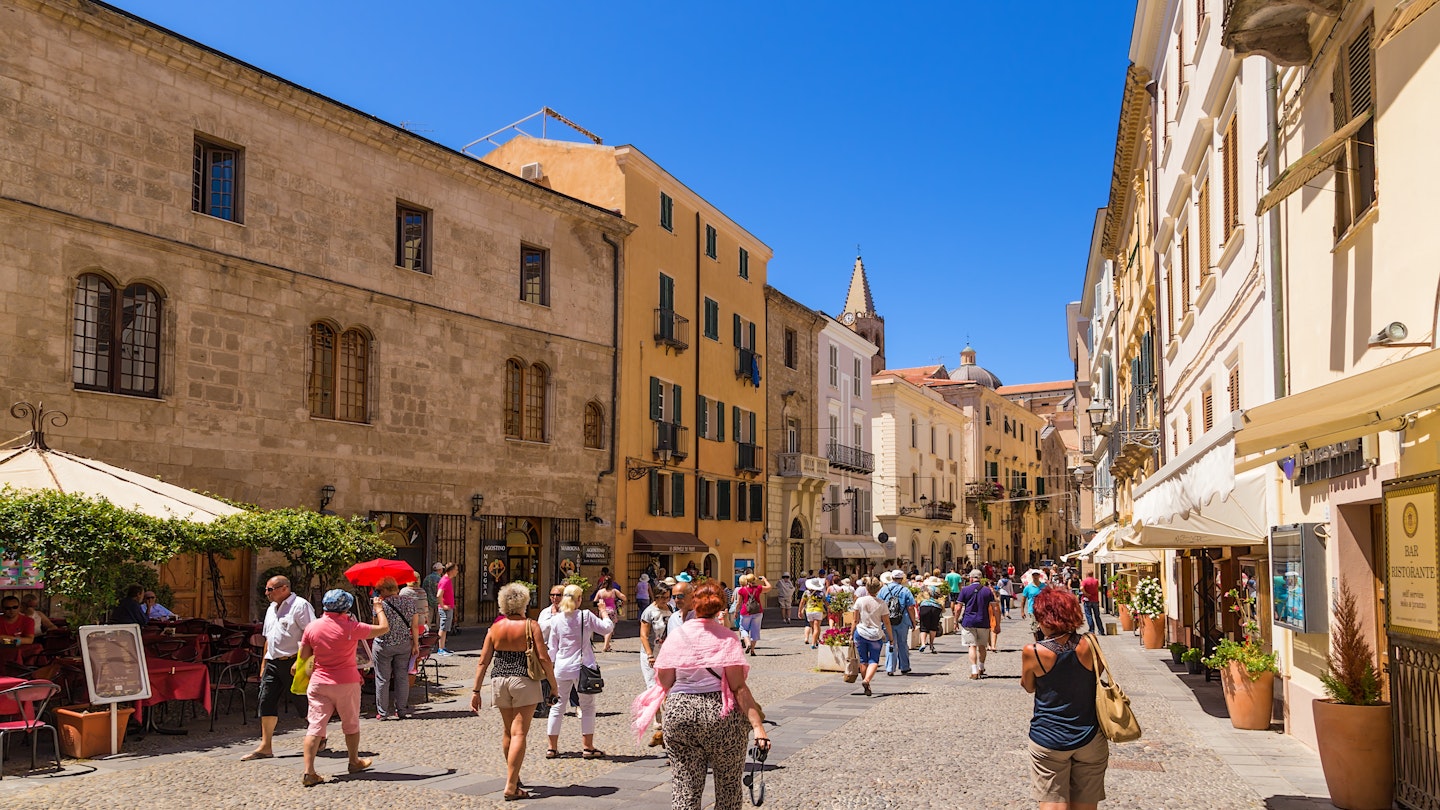 ALGHERO, SARDINIA, ITALY - JUL 07, 2016: Tourists on the street in the old town