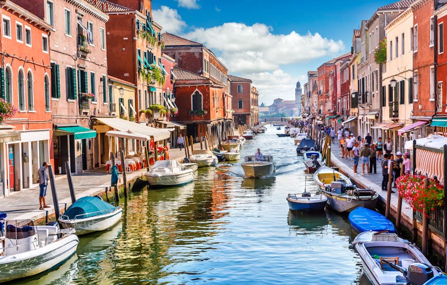 Visitors and boats in the canals of Murano Island