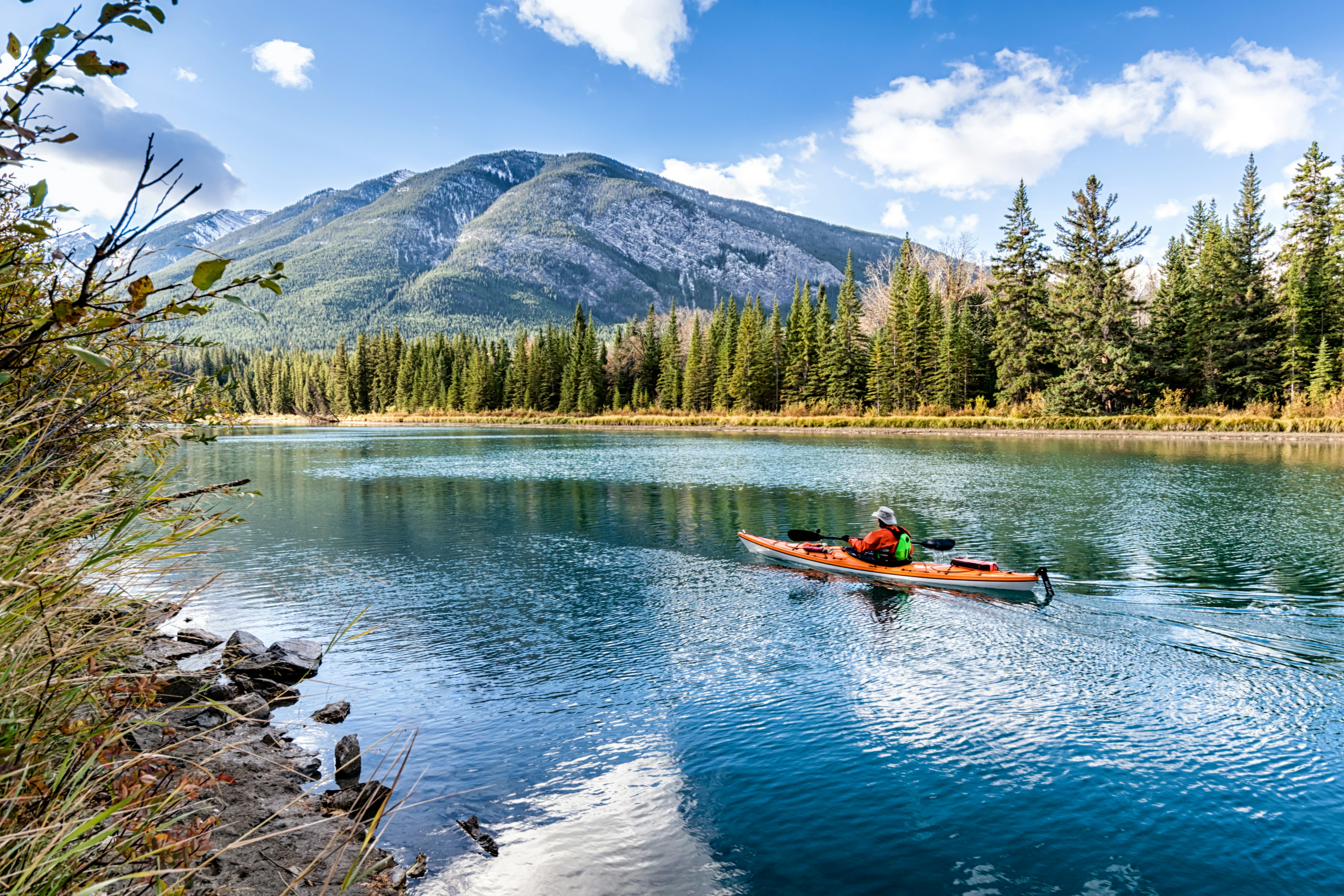 Kayaker on the Bow river near Banff in Alberta, Canada