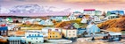 Panorama of colourful houses in Stykkisholmur, with snow-capped mountains beyond.