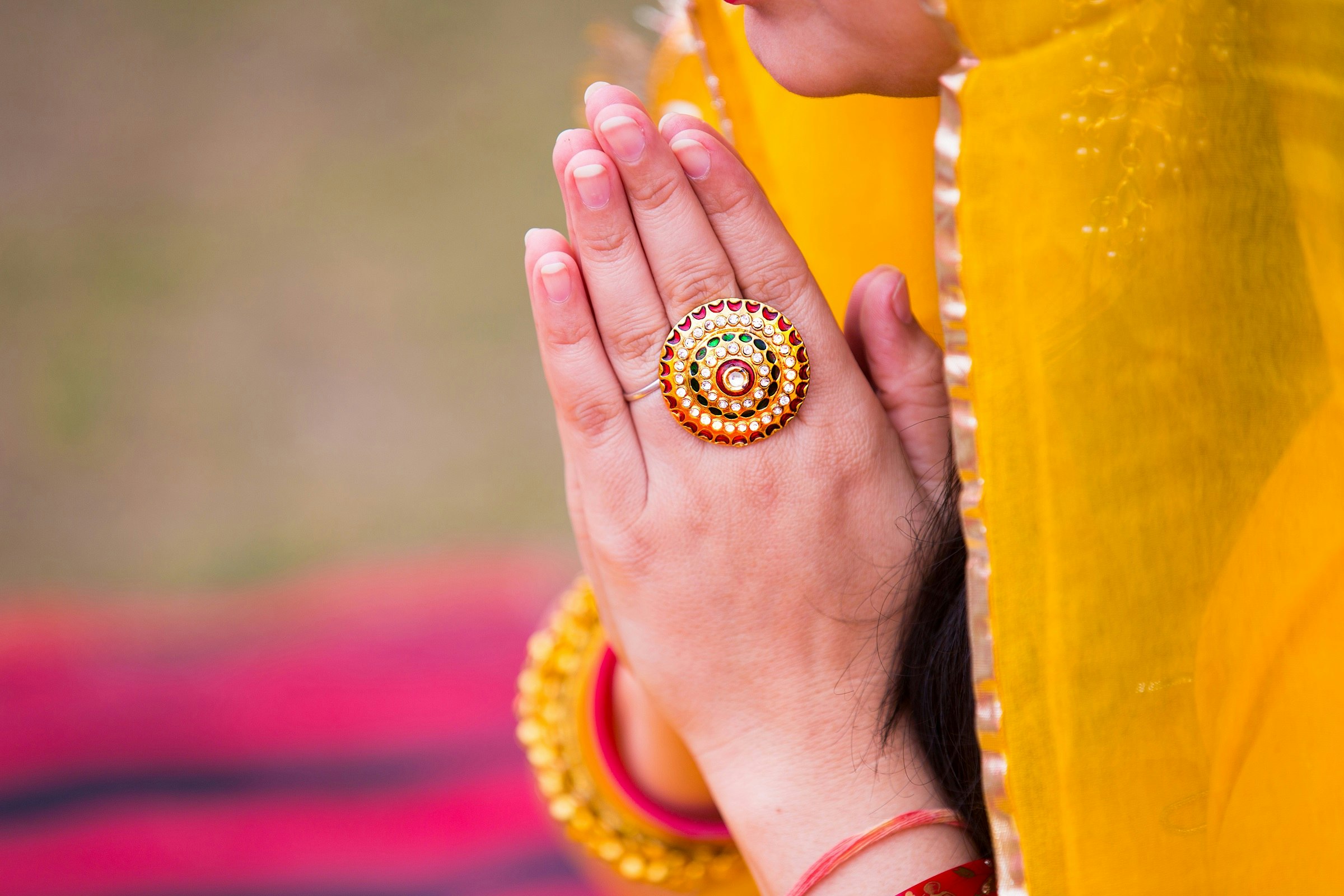 Closeup of an Indian woman's hands doing namaste