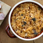 Bigos in stoneware dish and bigos ingredients: sausage, sauerkraut and cumin; Shutterstock ID 1536750086; Your name (First / Last): Jack Palfrey; GL account no.: 65050; Netsuite department name: Online Editorial; Full Product or Project name including edition: LP.com Article - Travel kitchen