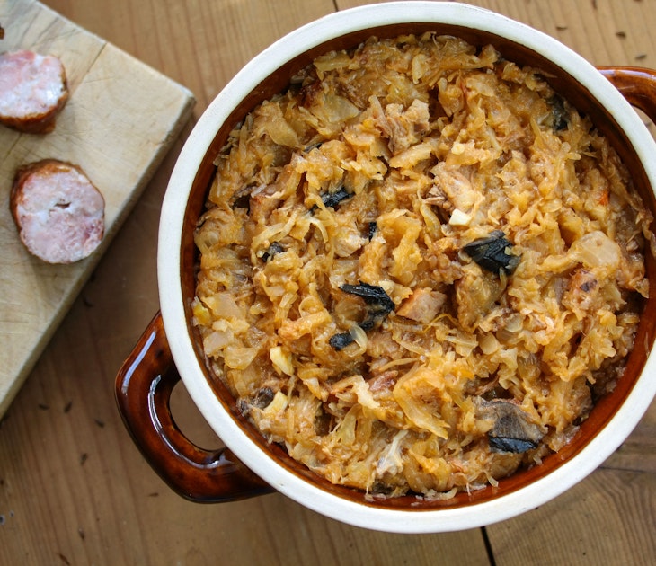Bigos in stoneware dish and bigos ingredients: sausage, sauerkraut and cumin; Shutterstock ID 1536750086; Your name (First / Last): Jack Palfrey; GL account no.: 65050; Netsuite department name: Online Editorial; Full Product or Project name including edition: LP.com Article - Travel kitchen