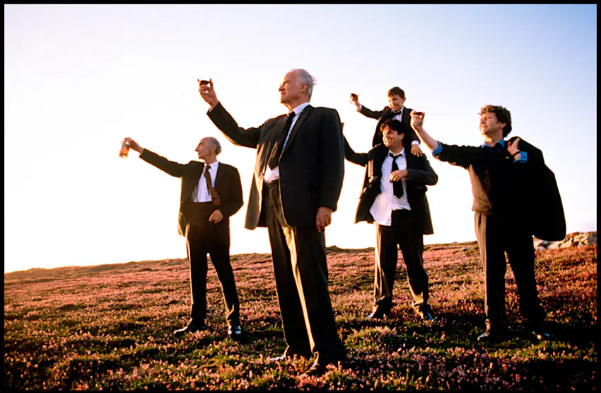 waking ned devine.jpg Four men and a boy raise a glass to the sky in the middle of a field. They are all wearong suit and looking in the same direction