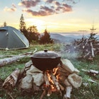 Tourist camp with fire, tent and firewood