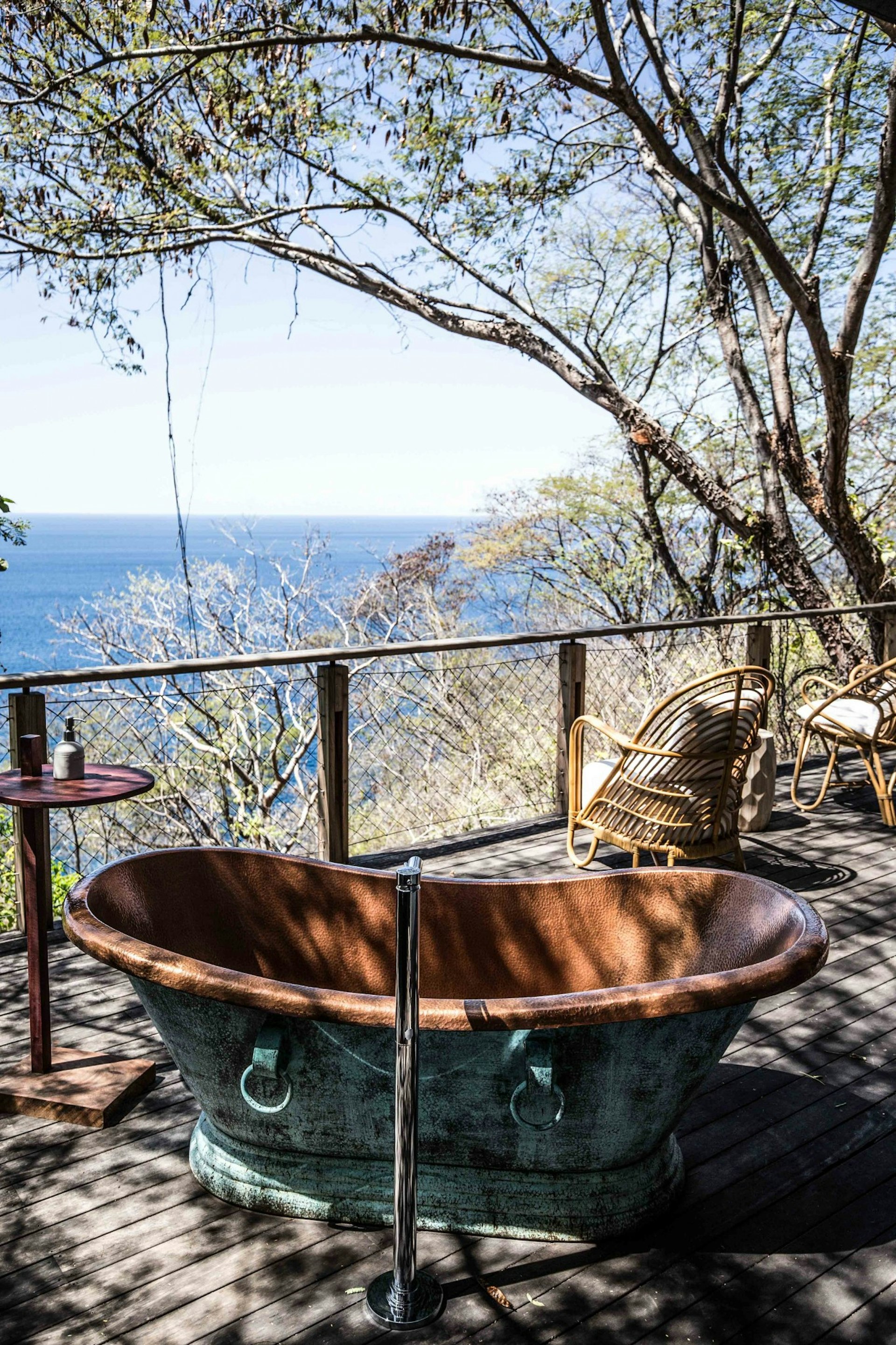 Outdoor brass bathtub in tropical forest