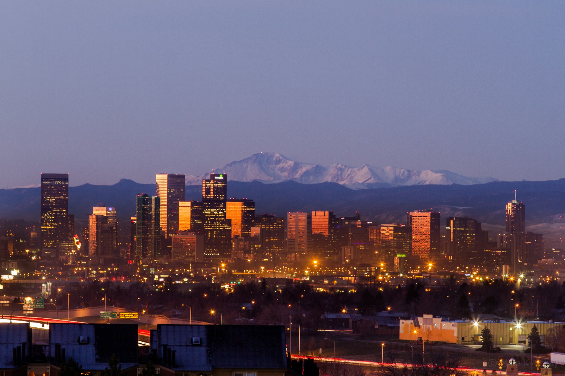 Denver city skyline at sunrise with Pikes Peak in the background