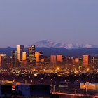 Denver city skyline photographed before sunrise with Pikes Peak Behind