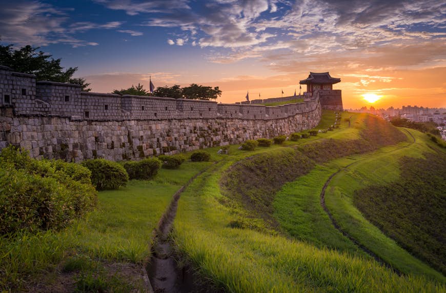 A huge stone wall ad a tower at the end at Hwaseong Fortress, South Korea