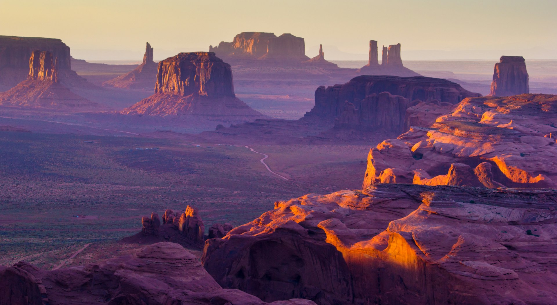 Sunset over rock formations in a desert landscape