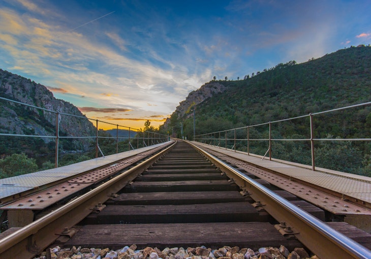 Railway road with mountains in background at sunset, Portugal