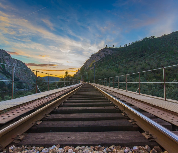 Railway road with mountains in background at sunset, Portugal