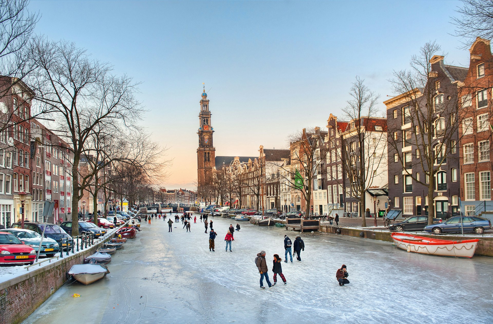 Skaters enjoy the ice on a winter evening on the Prinsengracht in Amsterdam, the Netherlands.