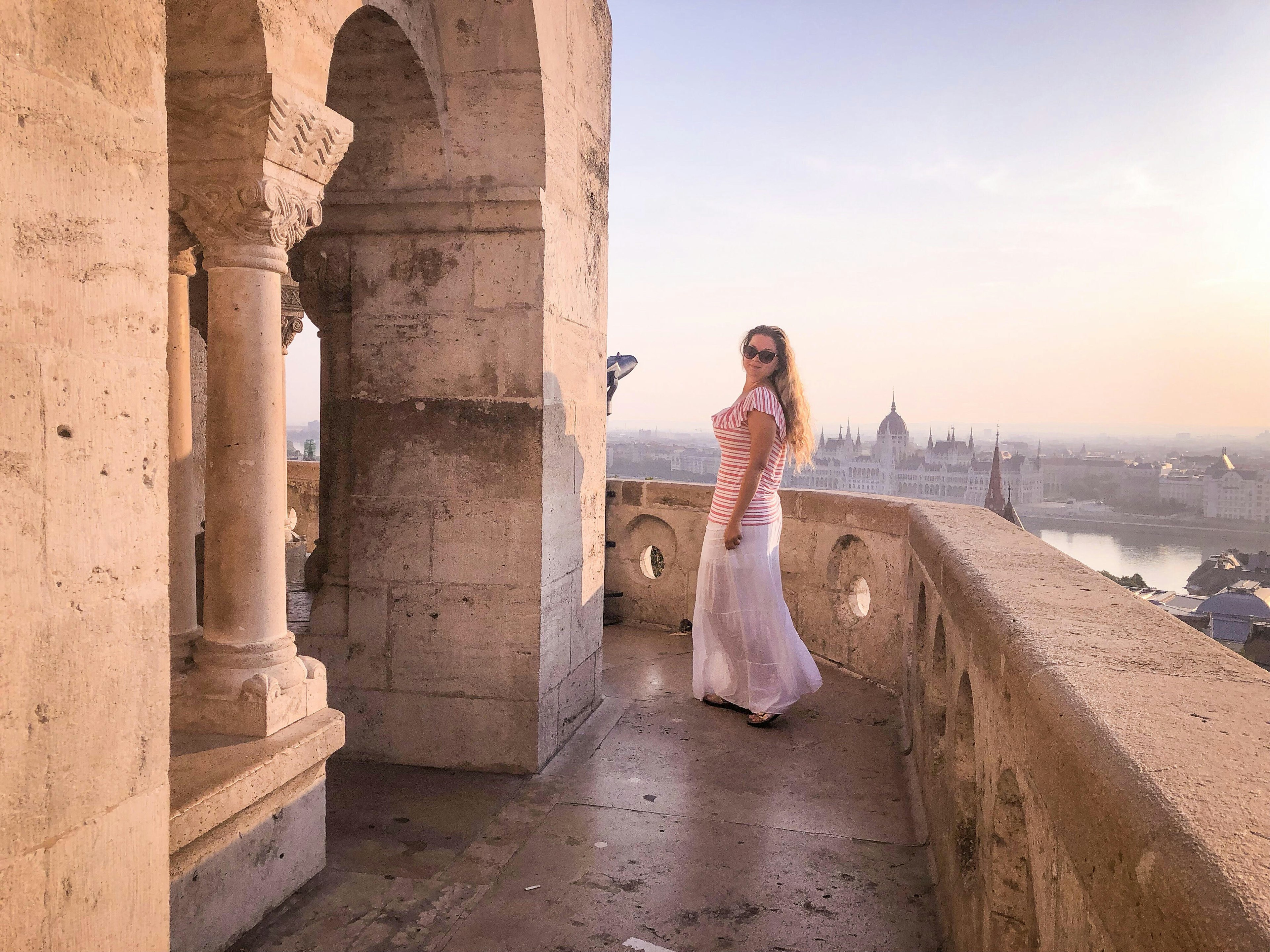 Ariane Henry wearing a long dress at a monument