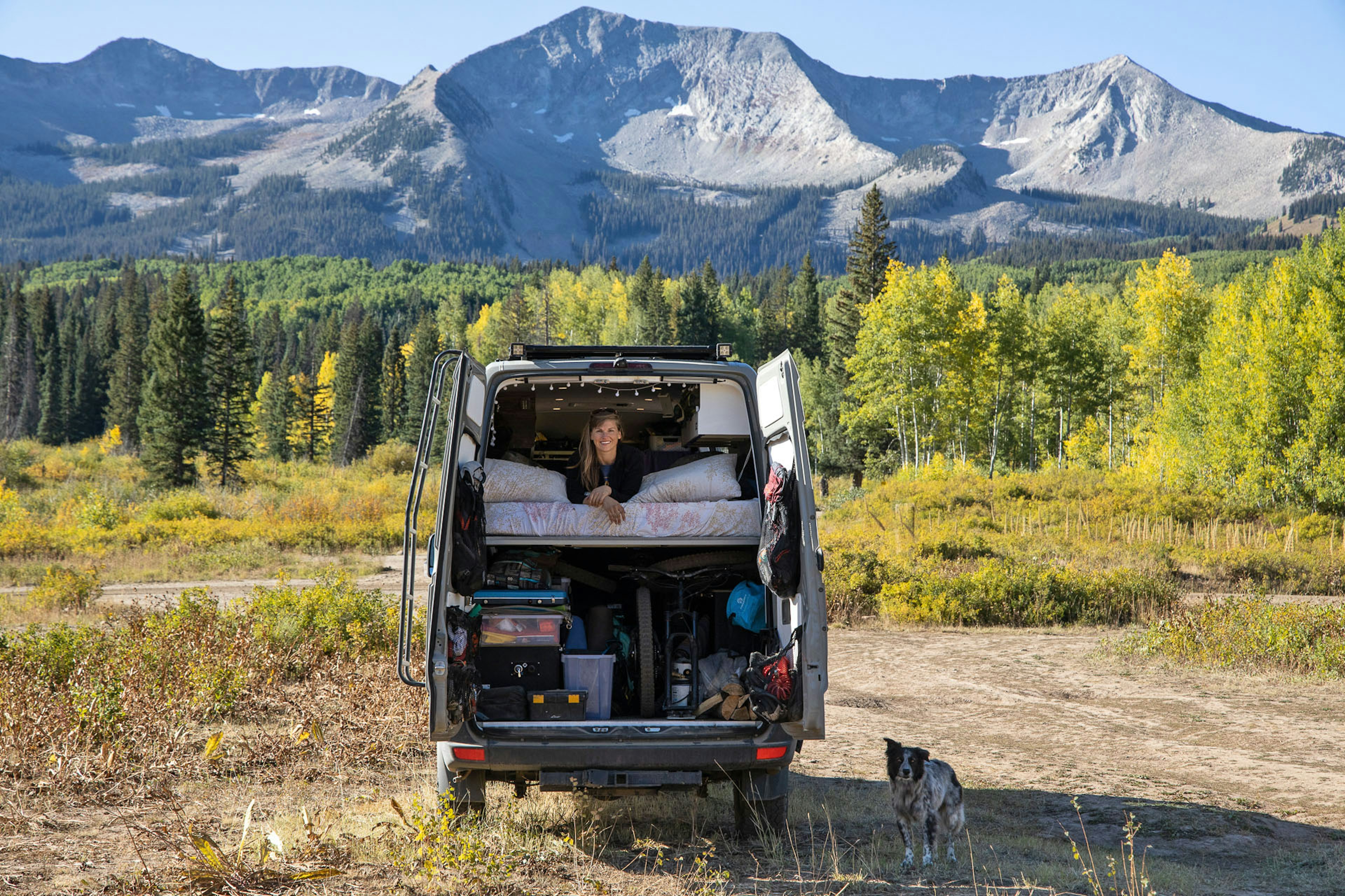 Woman sits on top of her camper van