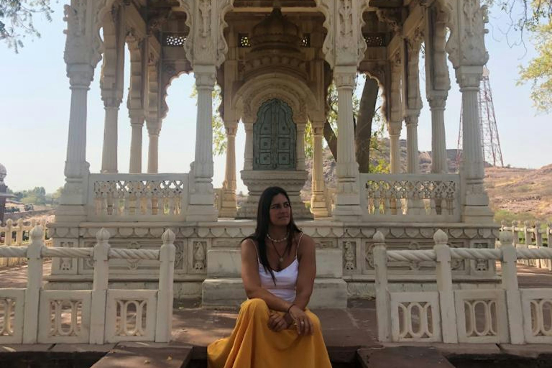 Catarina Almeida posing in front of a landmark on her travels