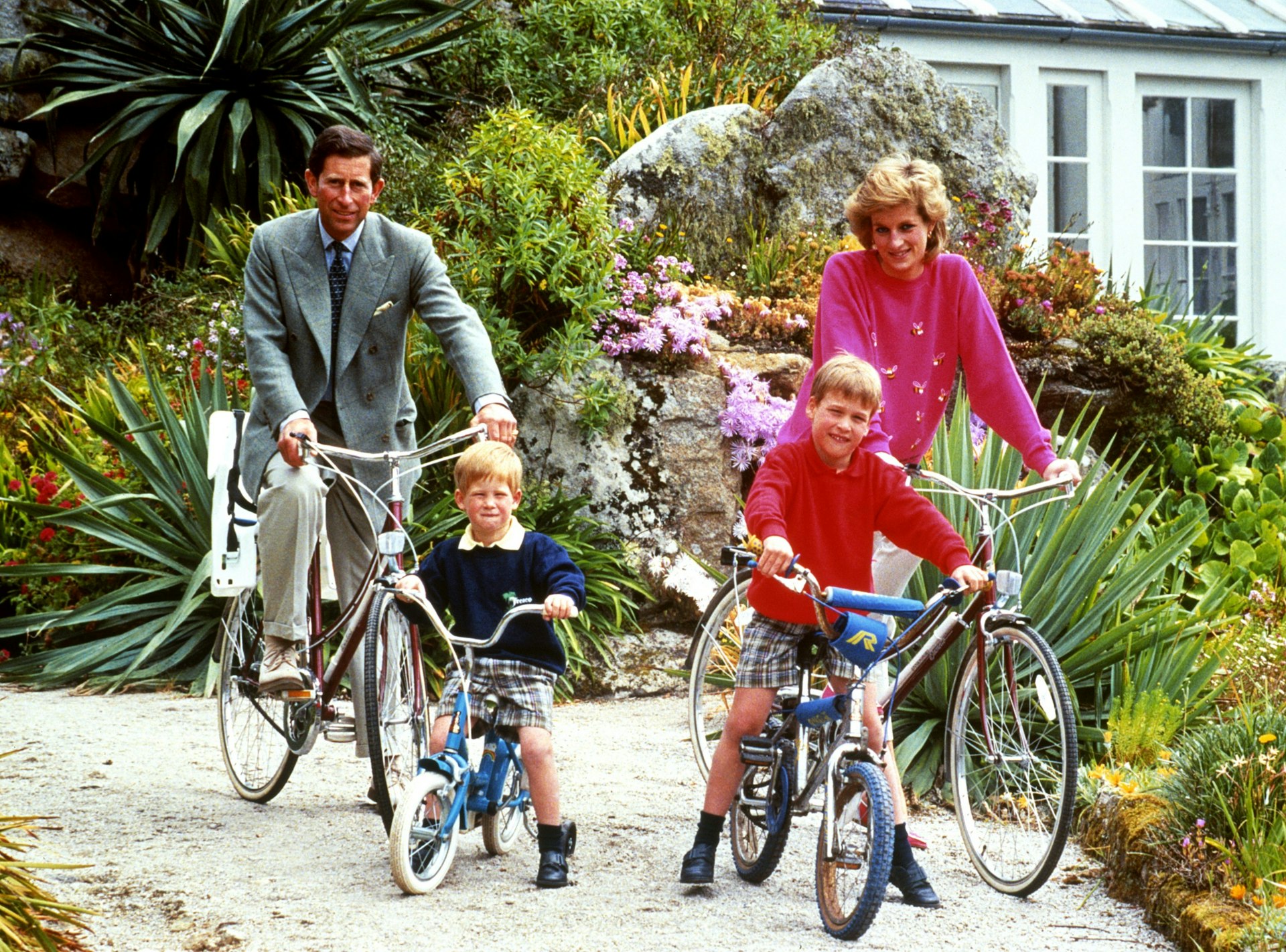 The Prince and Princess of Wales with sons Prince William, right, and Prince Harry prepare for a cycling trip in Tresco during their holiday in the Scilly Isles