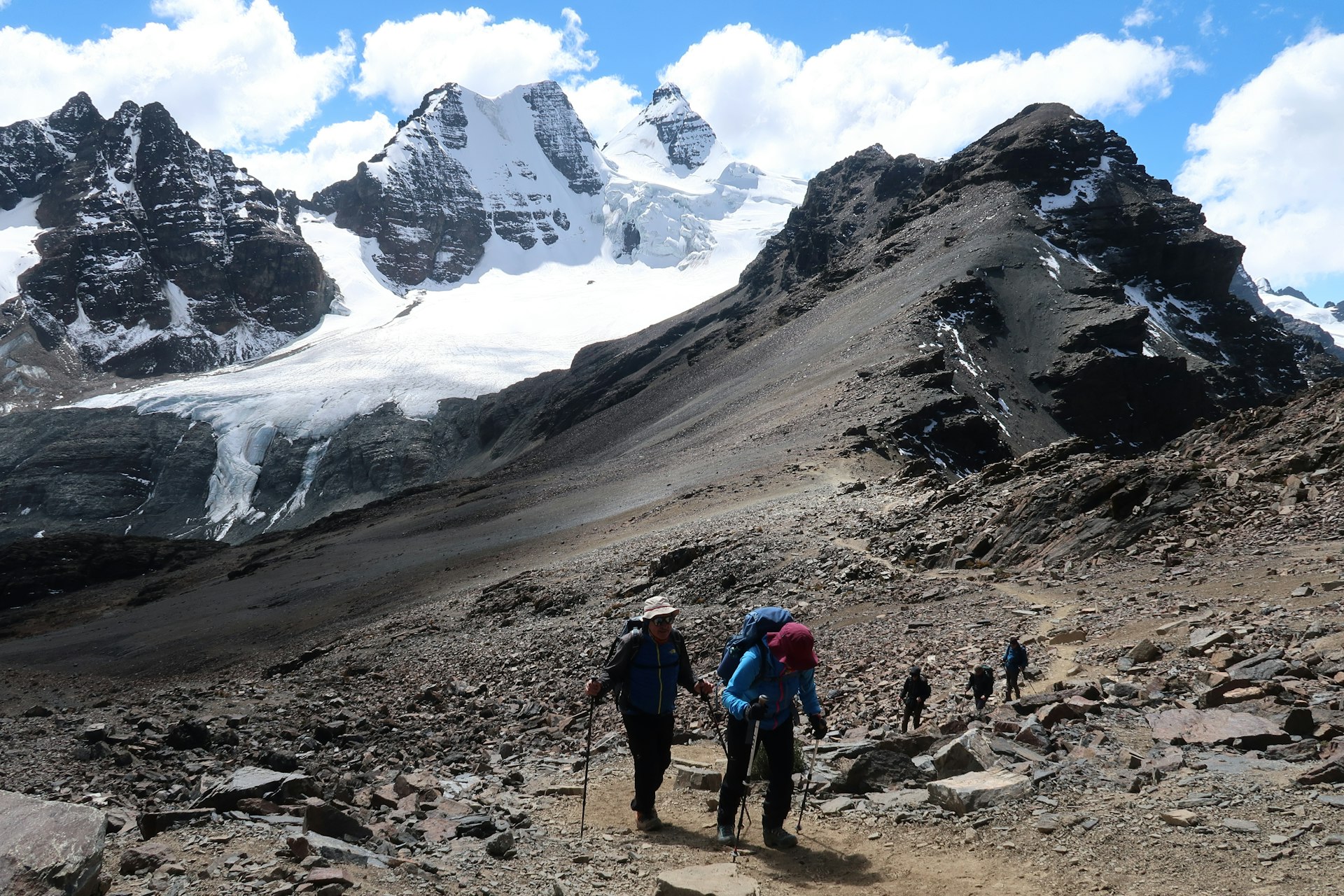 A trekking group among tall mountains
