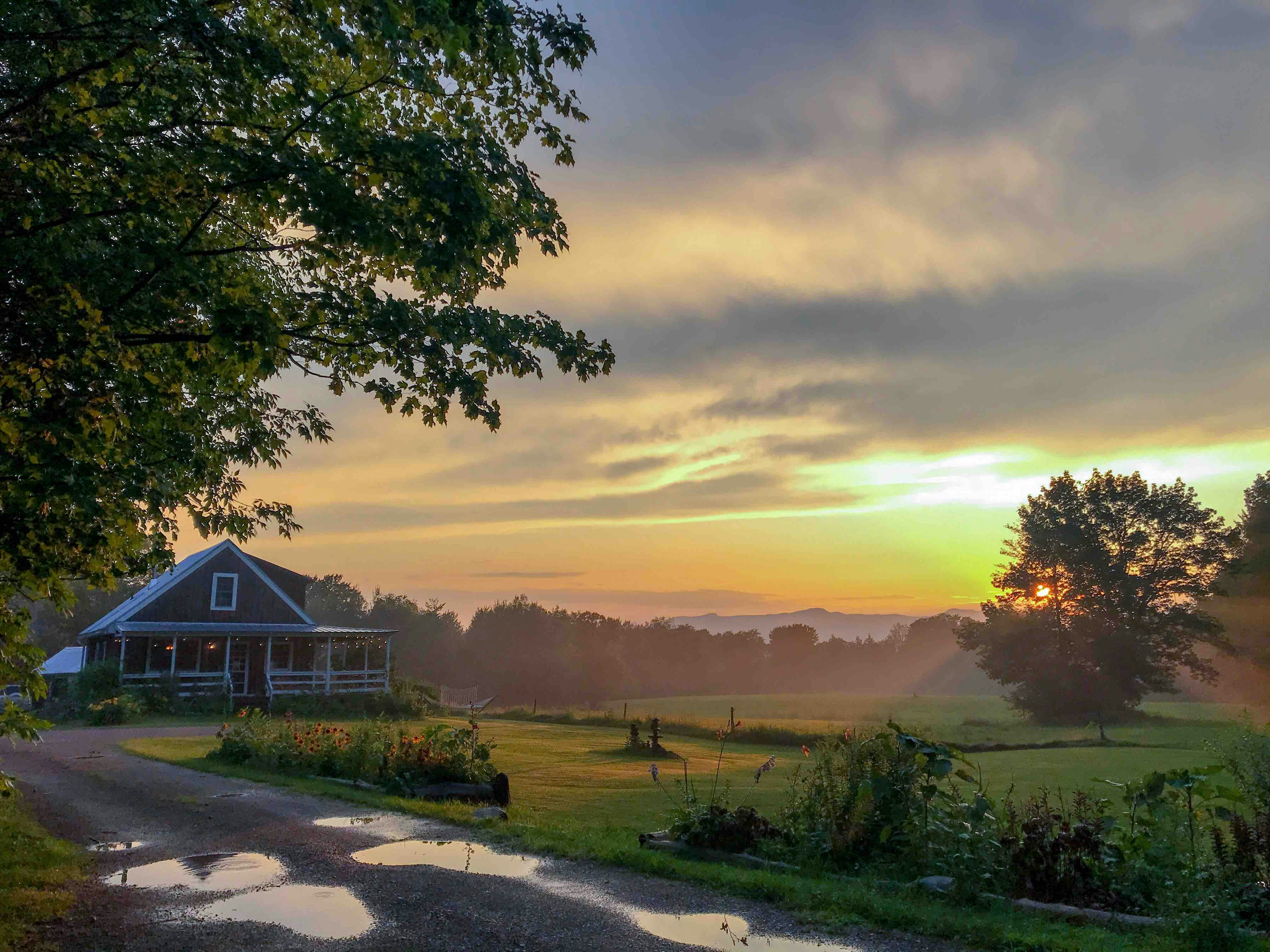 A colorful sky over a cozy Vermont cabin