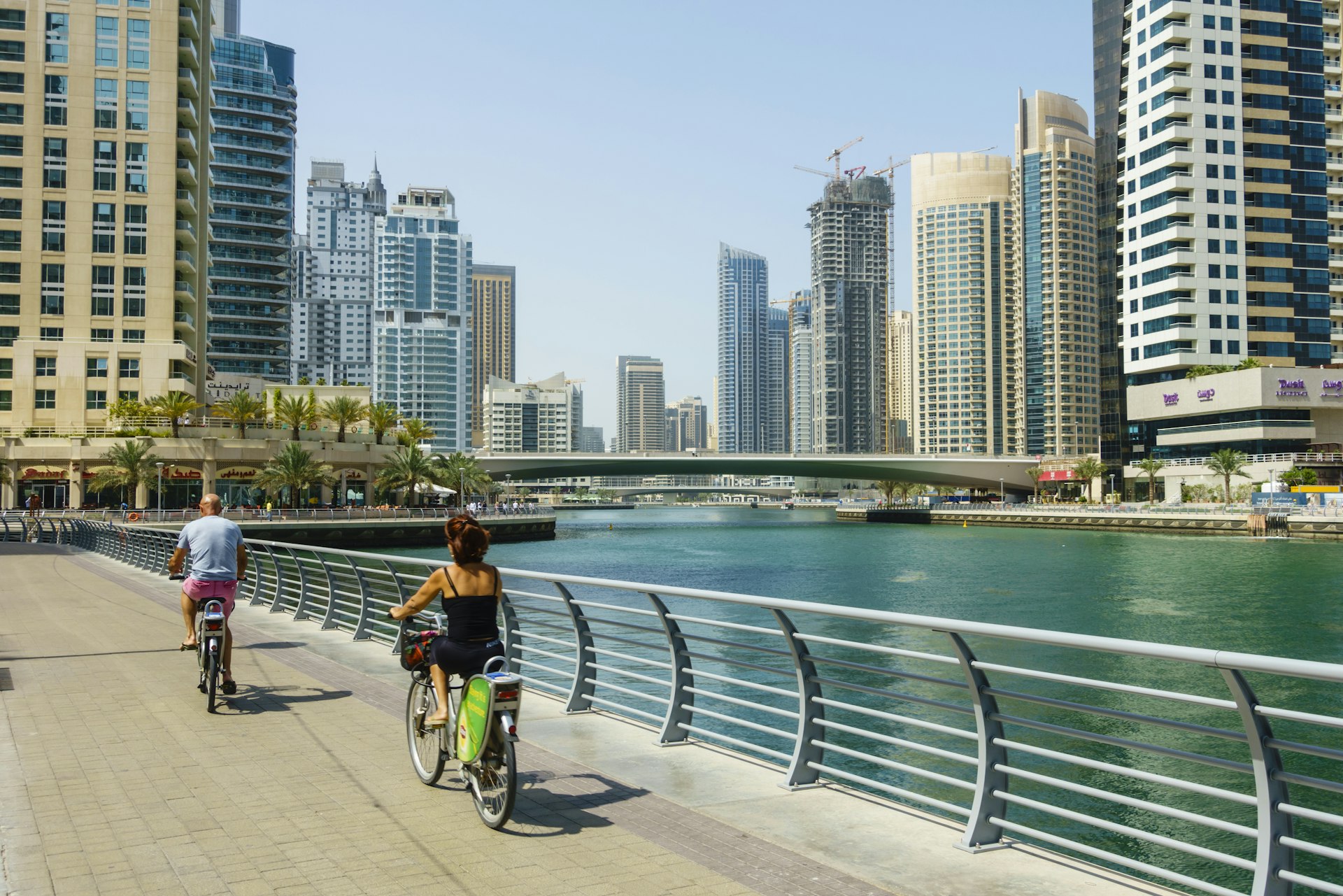 Cyclists on Marina Walk, Dubai Marina, Dubai