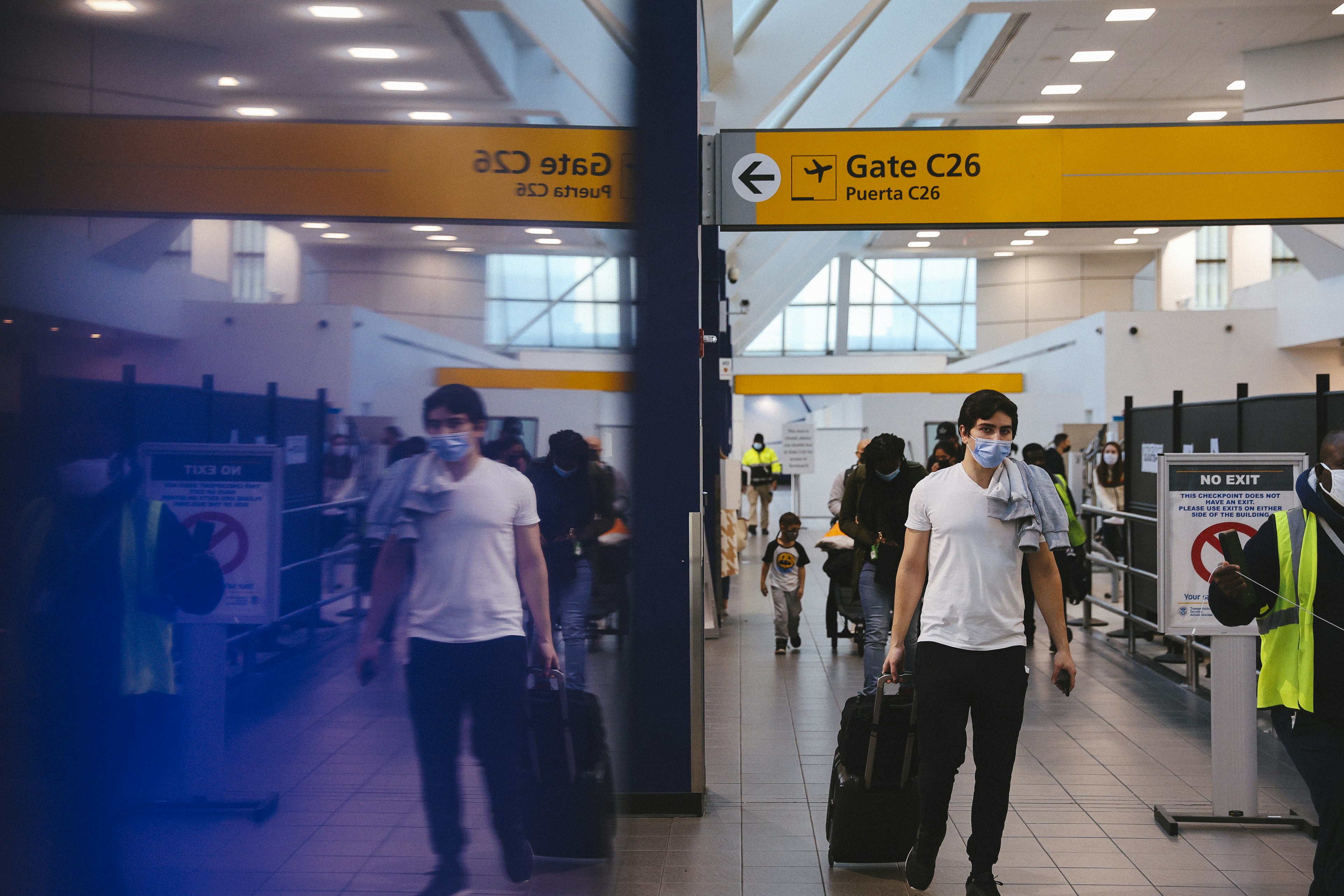 Travelers in masks at La Guardia airport