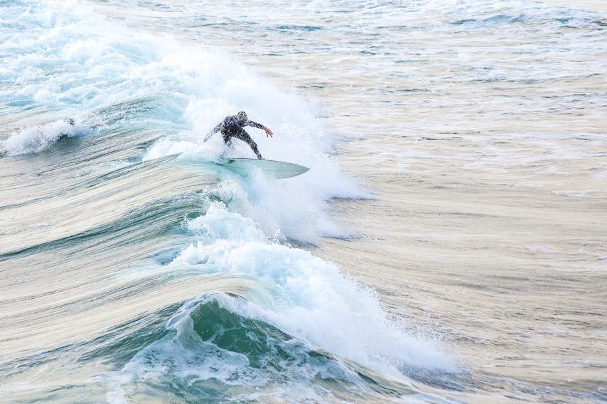 A surfer rides a wave in Bundoran, County Donegal, Ireland