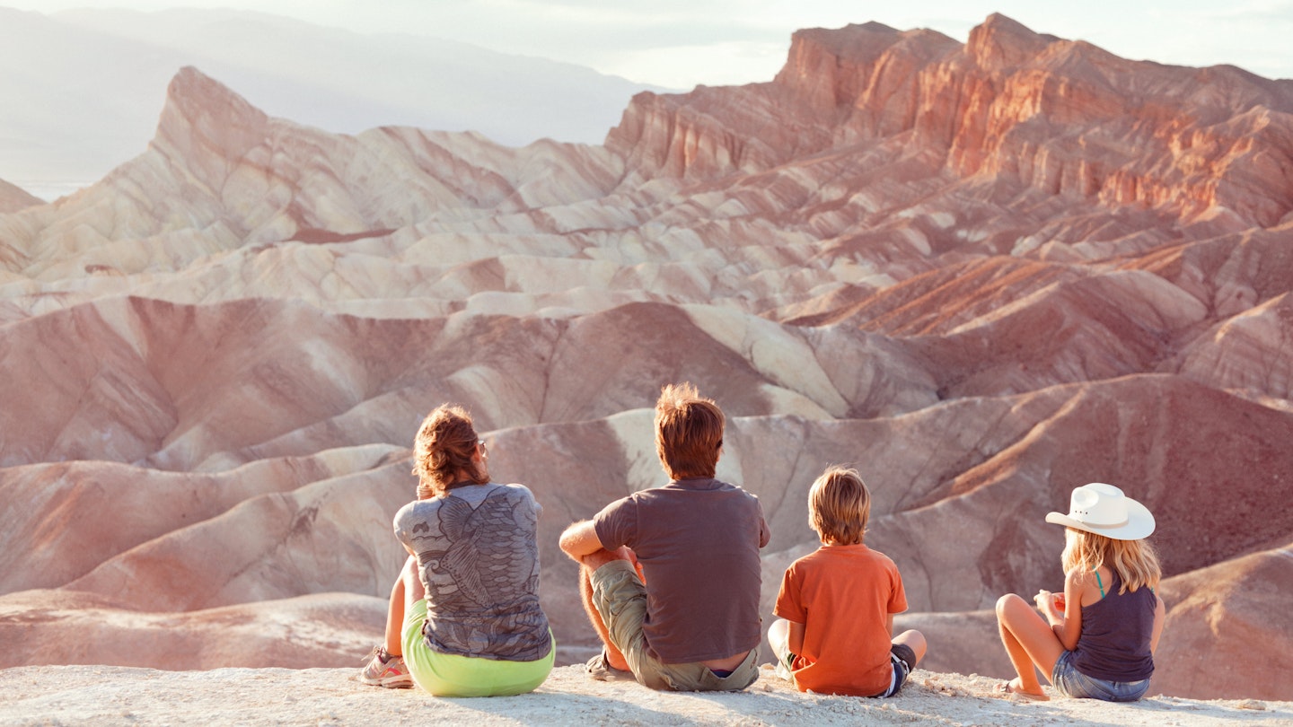 Family watching the sunset at Zabriskie Point in Death Valley.