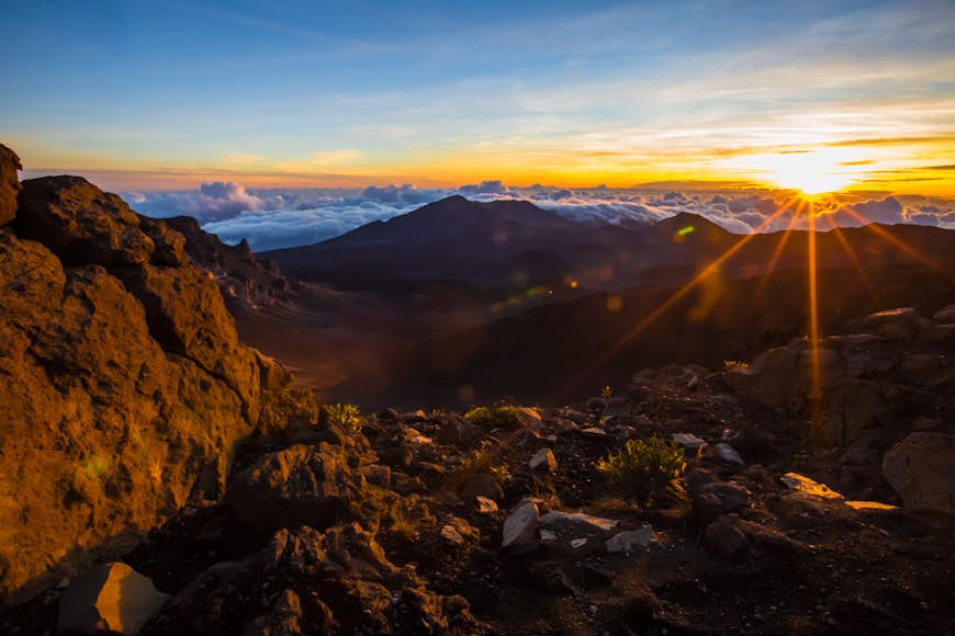 A sunset behind volcanic mountains at Haleakalā National Park, Hawaii