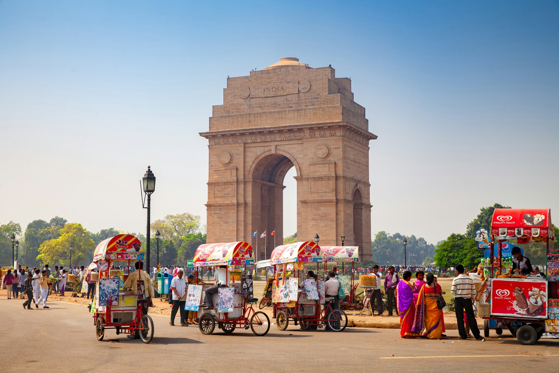 Many bicycle ice cream sellers in front of the India Gate